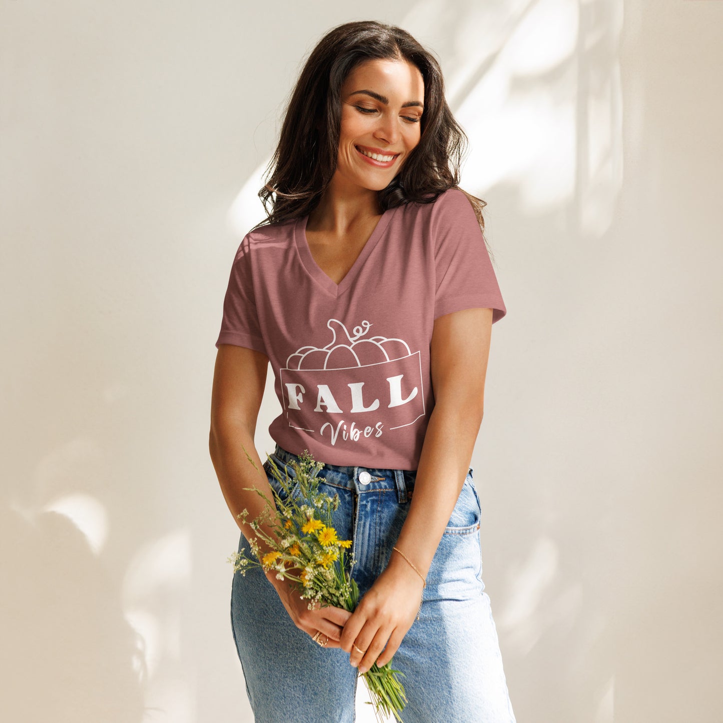 Fall-themed, mauve V-neck shirt that says "Fall Vibes" with white frame around it and a pumpkin on top.