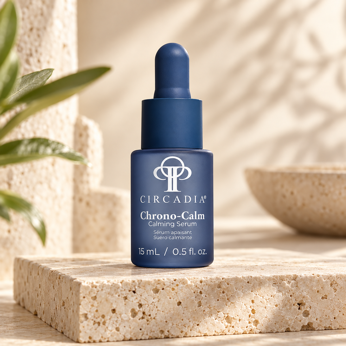 Circadia Chrono-Calm Calming Serum in a dark blue glass dropper bottle, displayed on a textured beige stone pedestal with a blurred natural background.