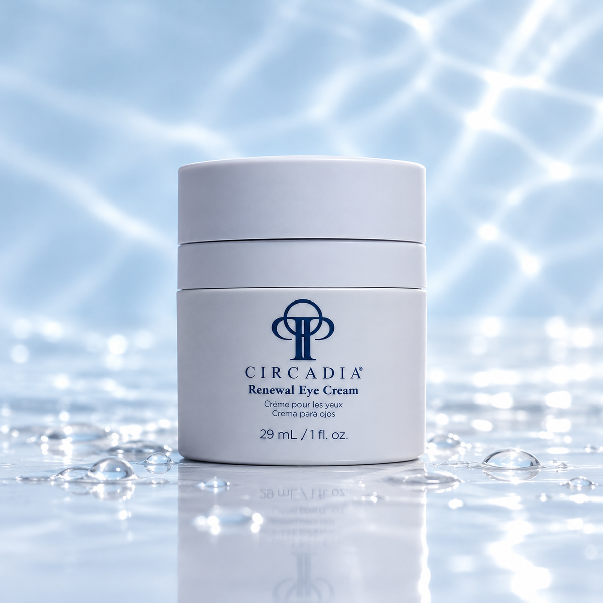 A white jar of Circadia Renewal Eye Cream with a blue logo, set against a shimmering, water-like blue background with water droplets on a reflective surface.